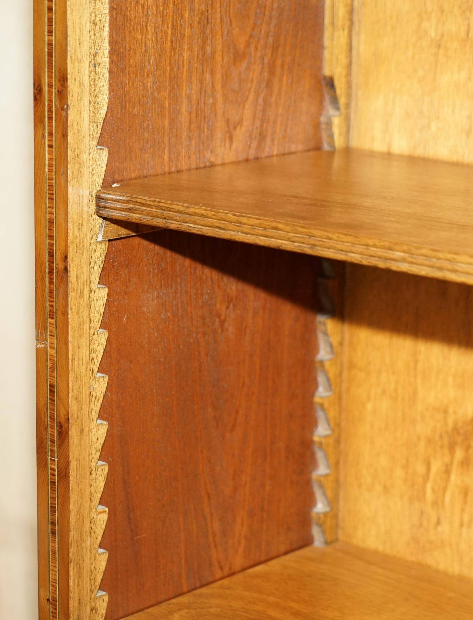 Pair of Sheraton Revival bookcases in satinwood, walnut, and yew.