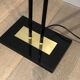 Black lacquered metal floor lamp with brass.