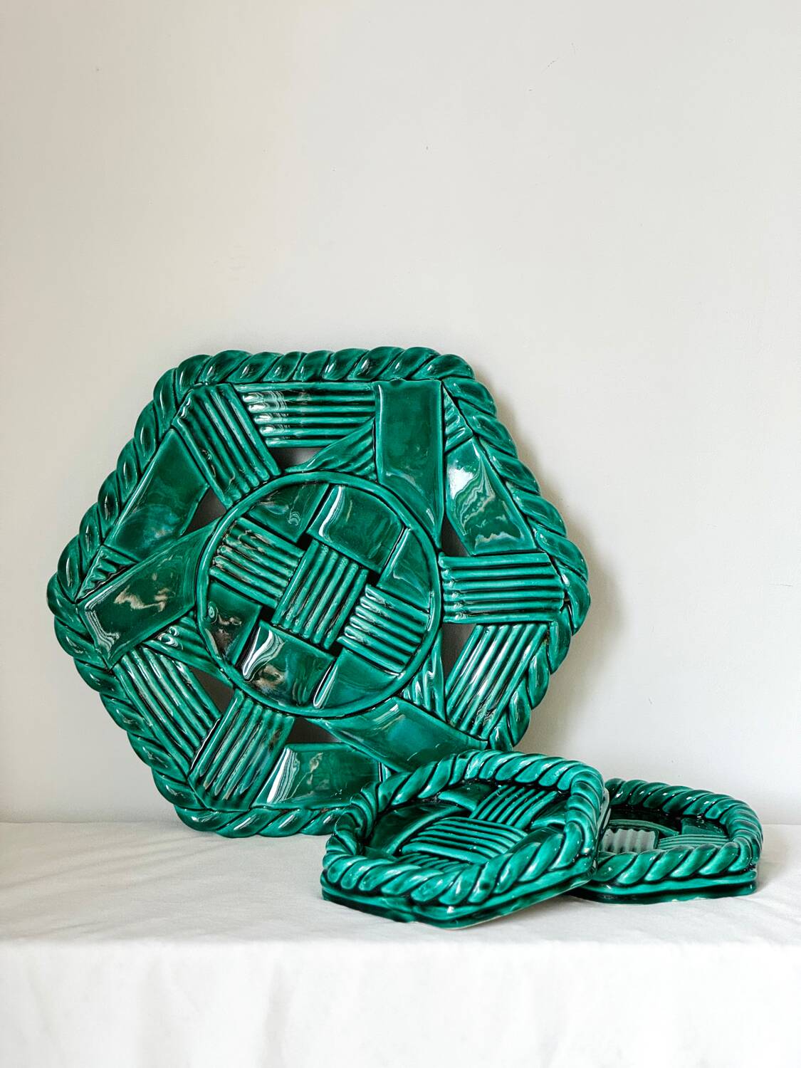 Trio of barbotine art deco coasters and bottle coasters