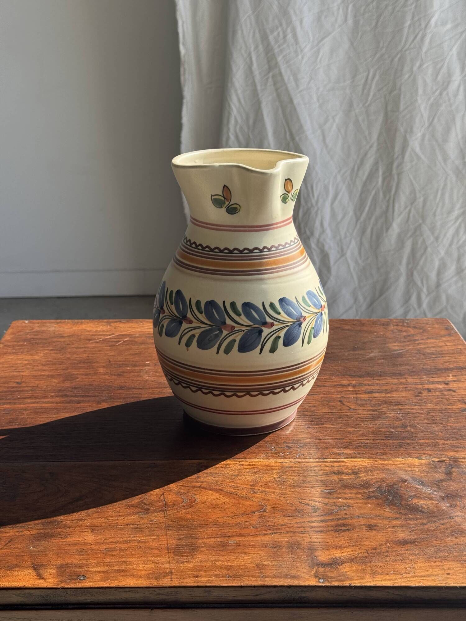 Beige carafe with stylized blue flower friezes