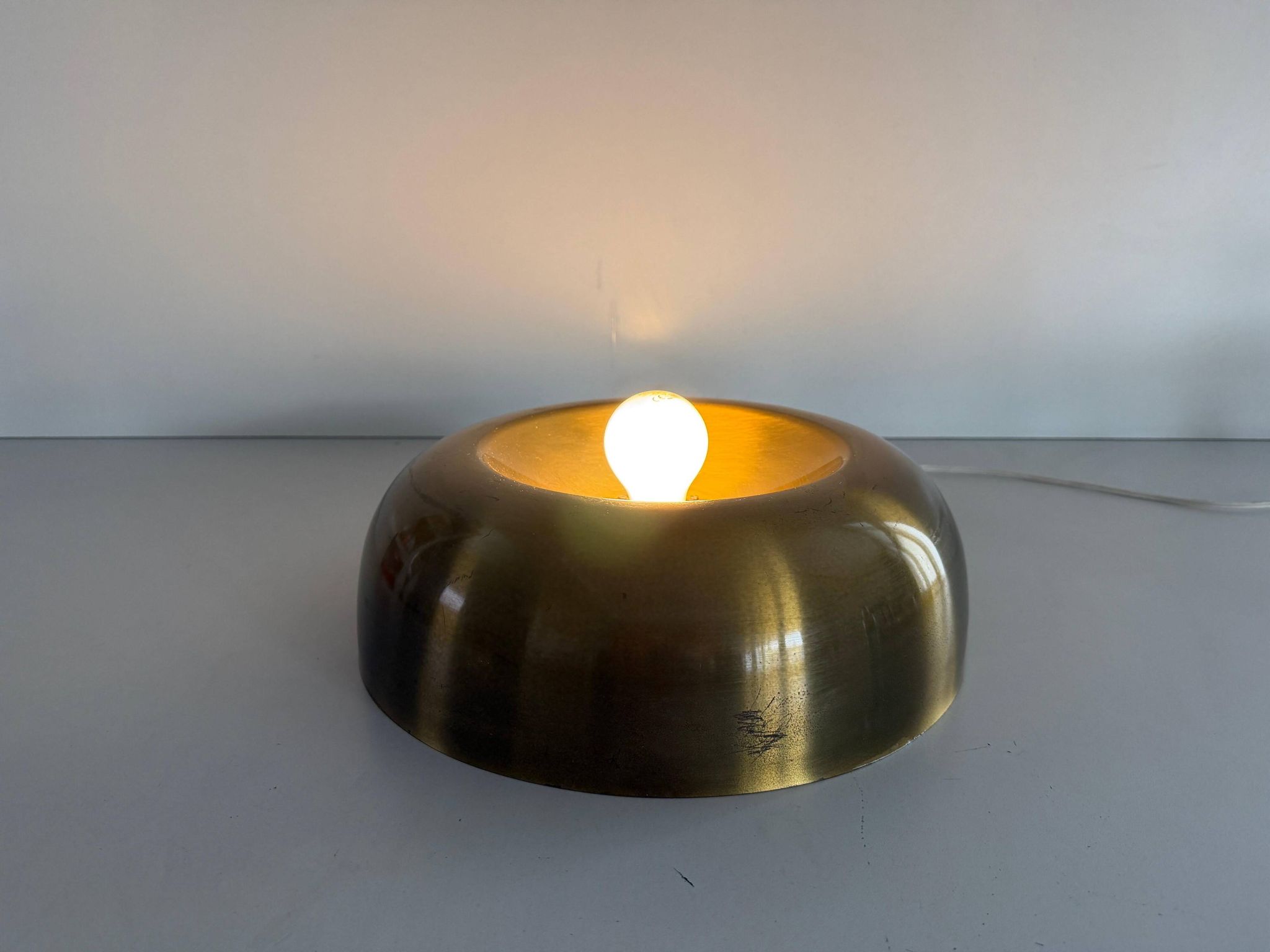Flush-mounted disc-shaped brass fixture from the mid-century, 1960, Italy.