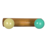 Vintage wall coat rack with 2 yellow and green balls.