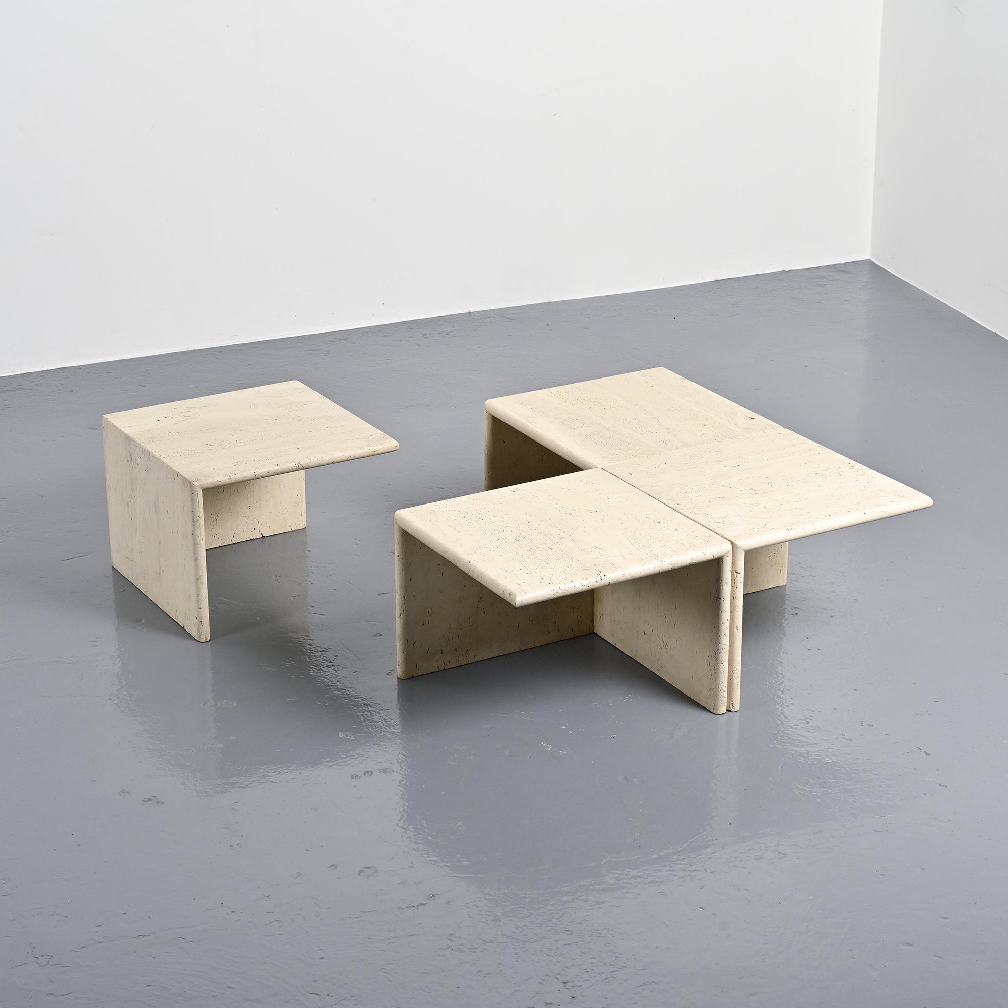 Set of four side tables in travertine, Italy, 1970s.