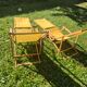 2 vintage Chilean deck chairs made of wood and yellow fabric printed with sailboats, with footrests.