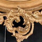 Large oval mirror in gilded wood