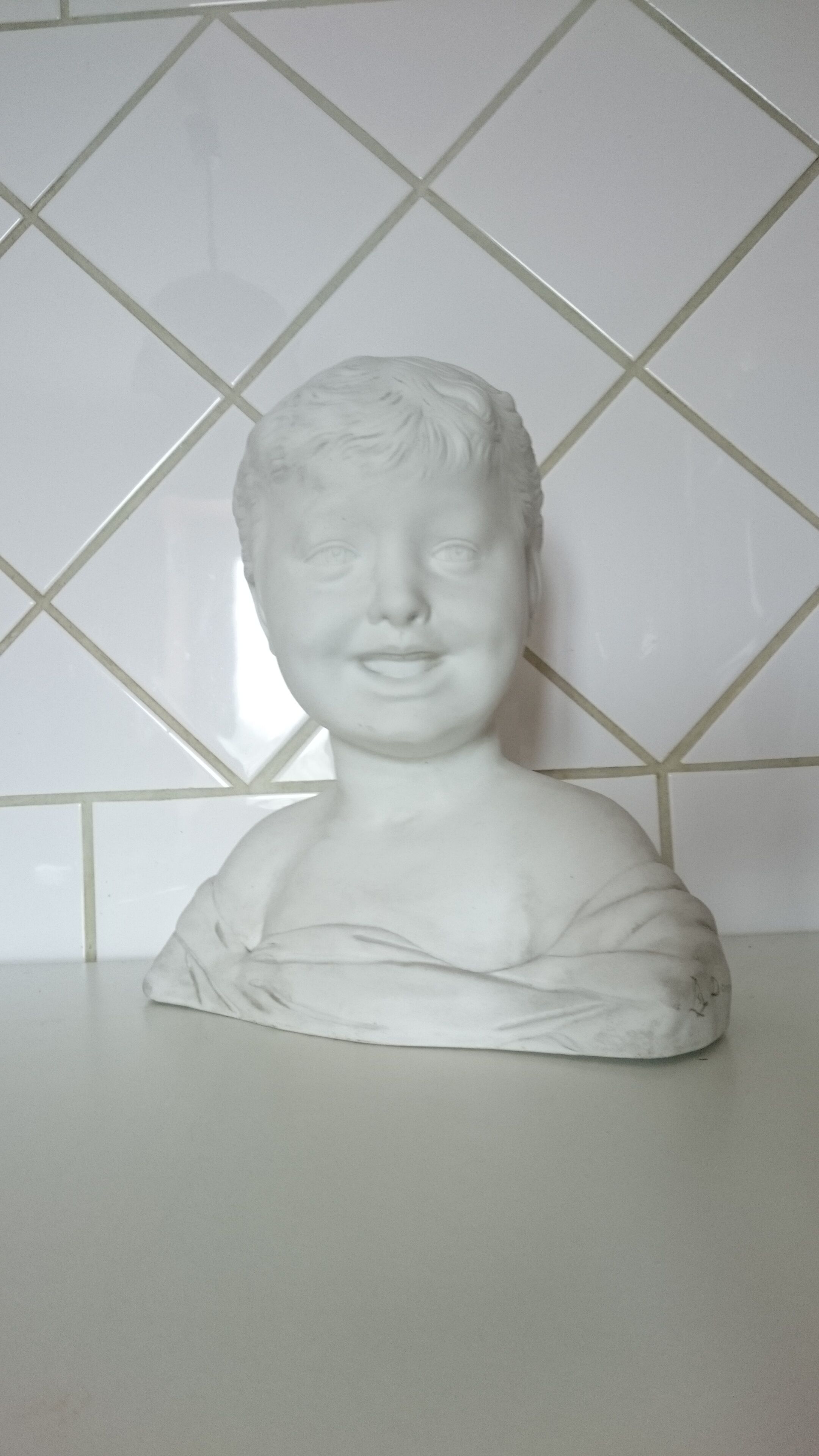 Laughing child bust after Donatello in Sèvres biscuit
