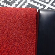 Pair of vintage armchairs in black faux leather and red fabric.