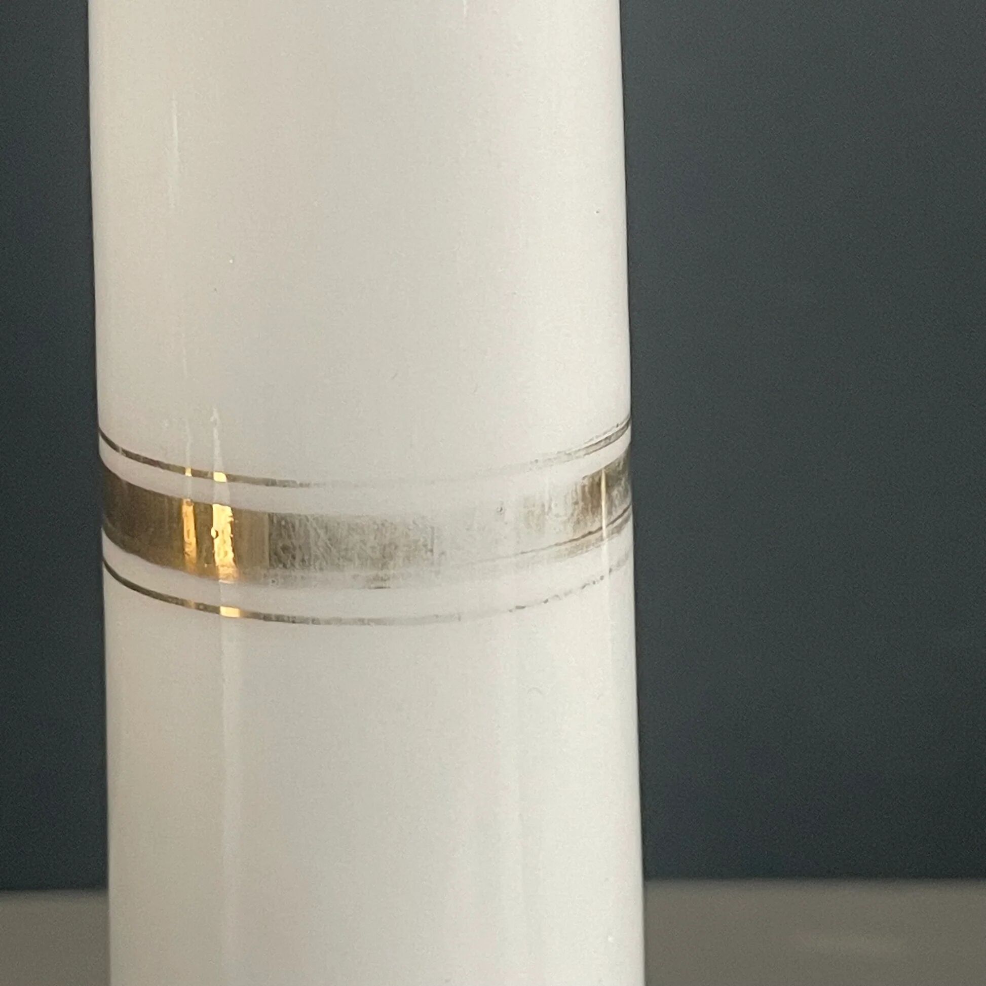 Pair of porcelain candlesticks with a gold pattern.