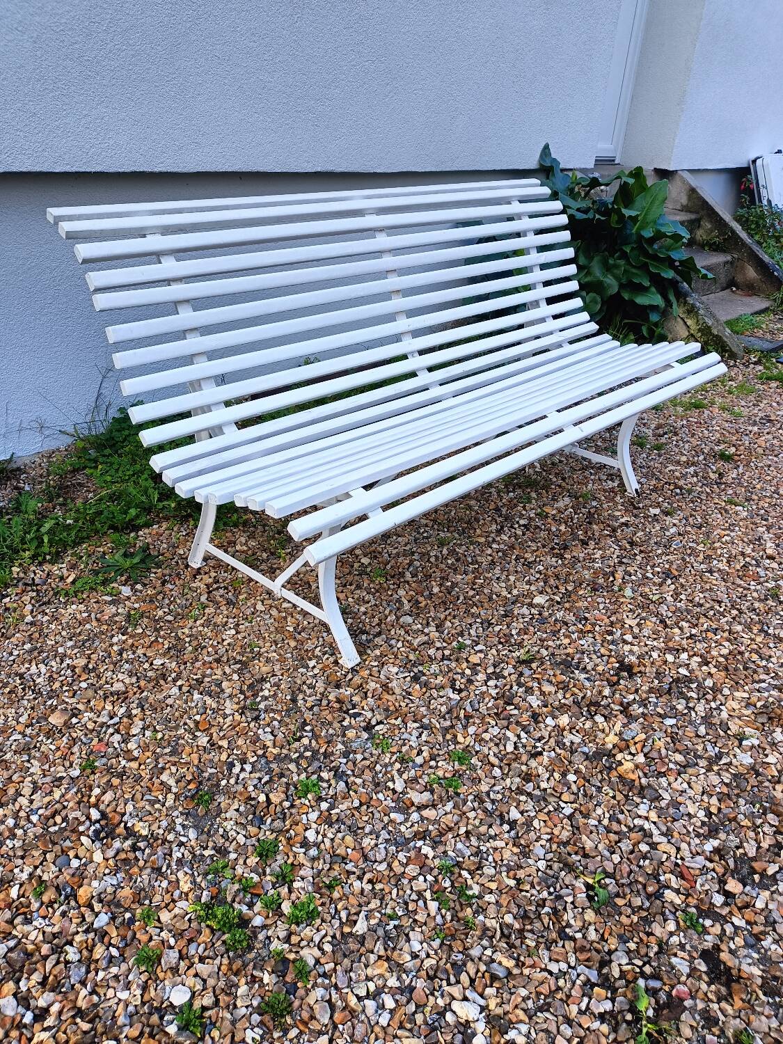 Old garden bench with metal legs and wooden slats