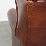 English style sheepskin leather wingback chair in a cognac color
