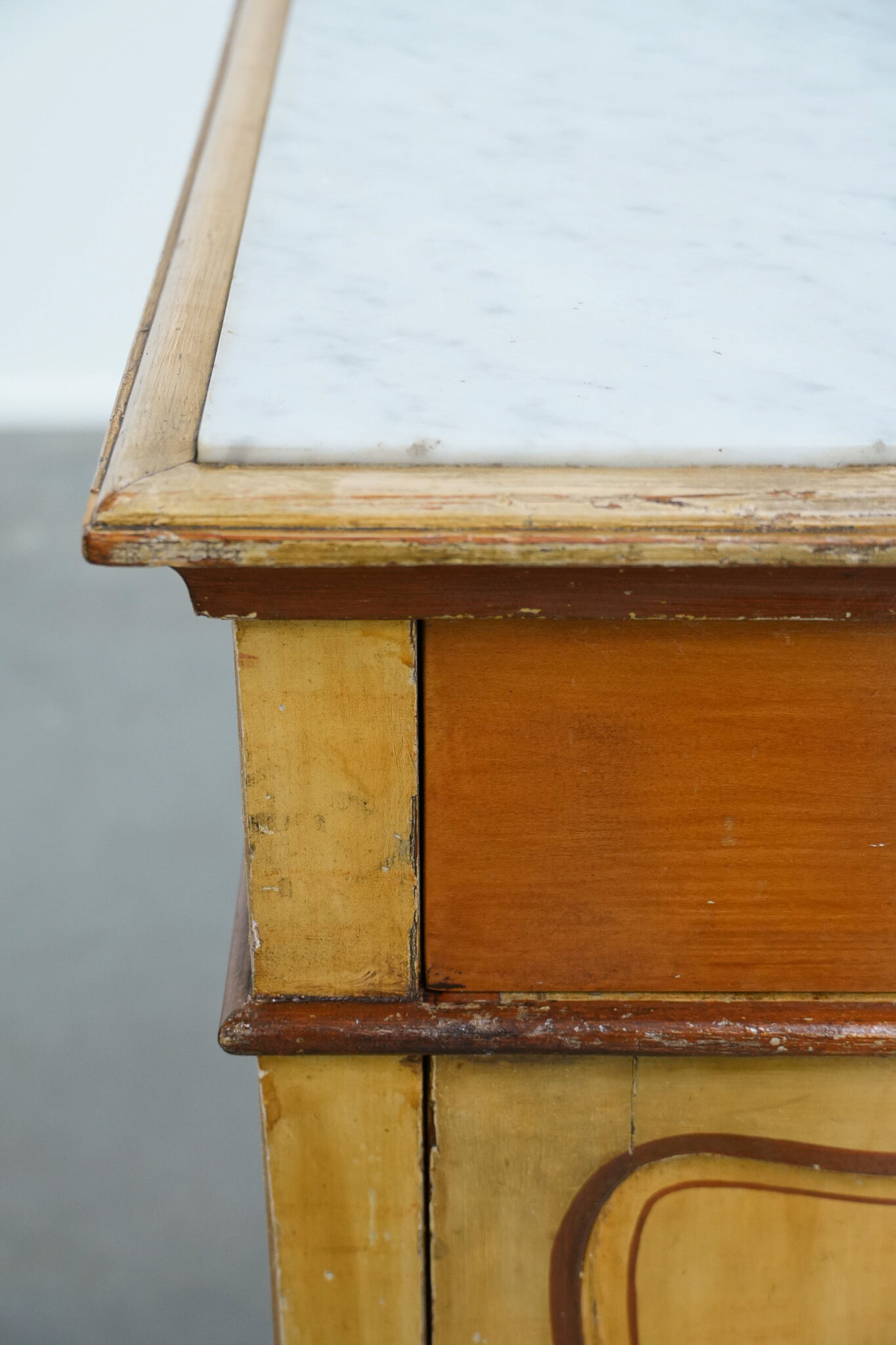 Antique wooden 1-door hallway/nightstand with a light marble top