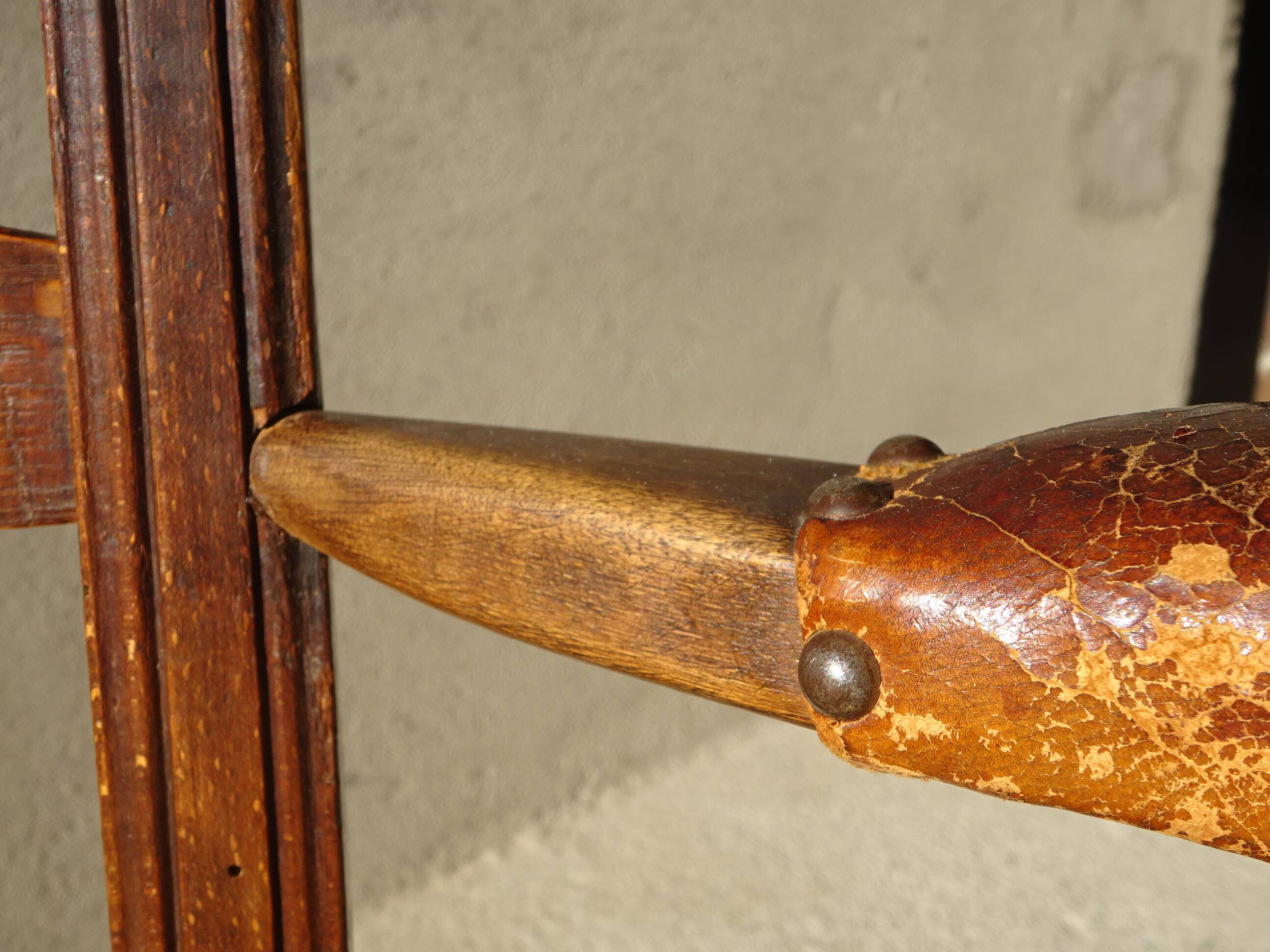 old armchair with leather armrests, from the 19th century