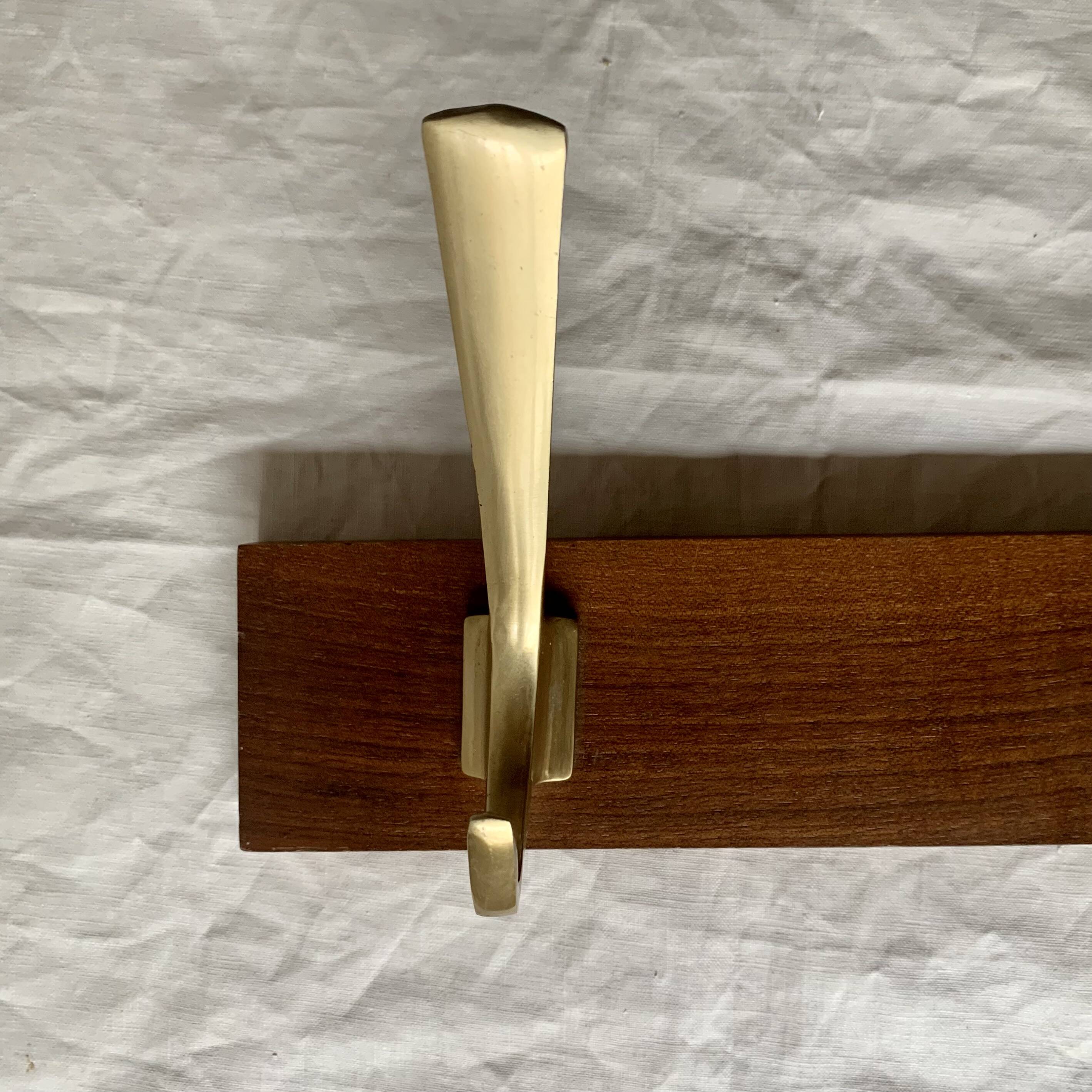 Vintage wooden wall-mounted coat rack with 3 golden cast aluminum hooks