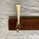 Vintage wooden wall-mounted coat rack with 3 golden cast aluminum hooks