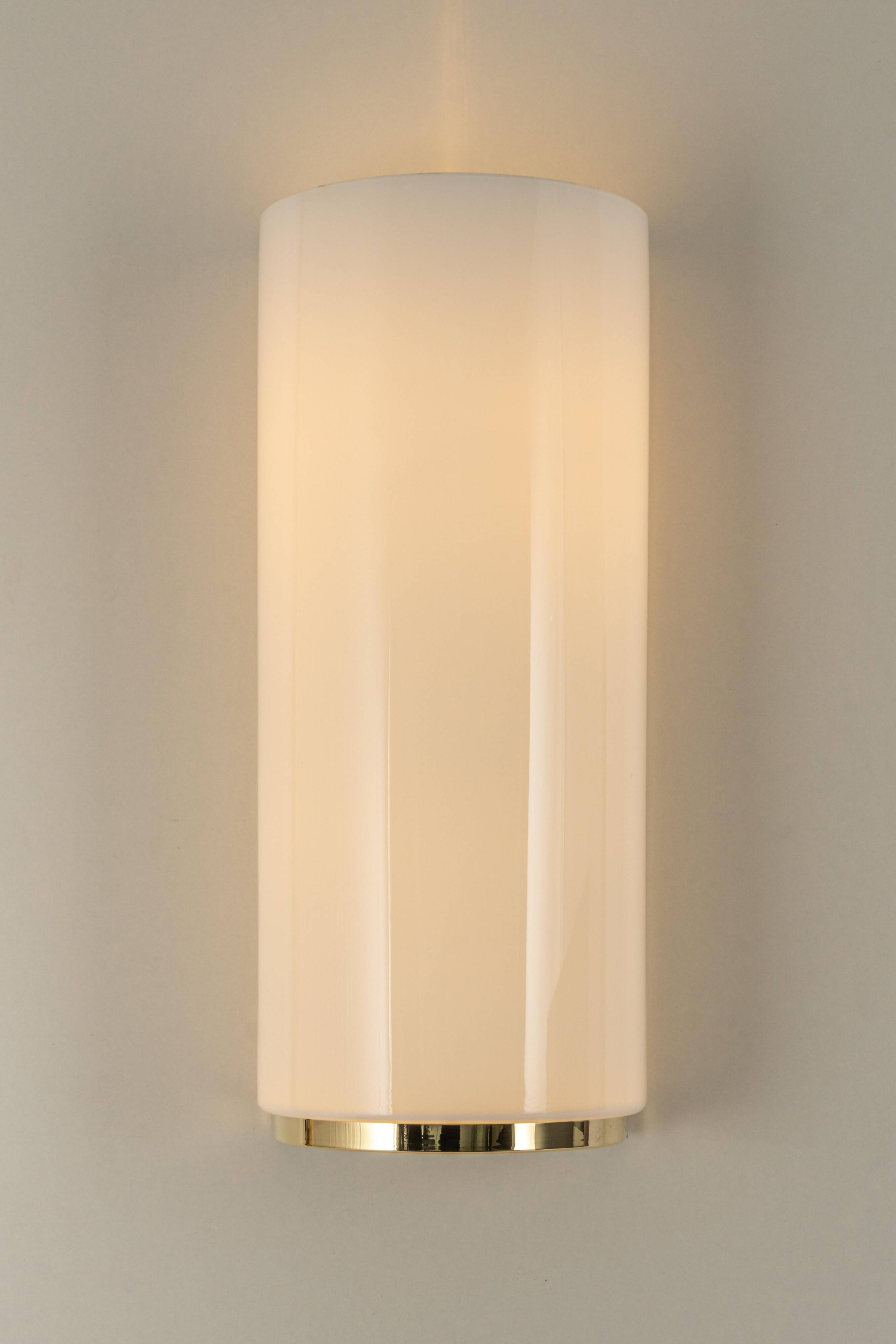 Pair of large opaline glass wall lights in brass designed by Limburg, Germany.