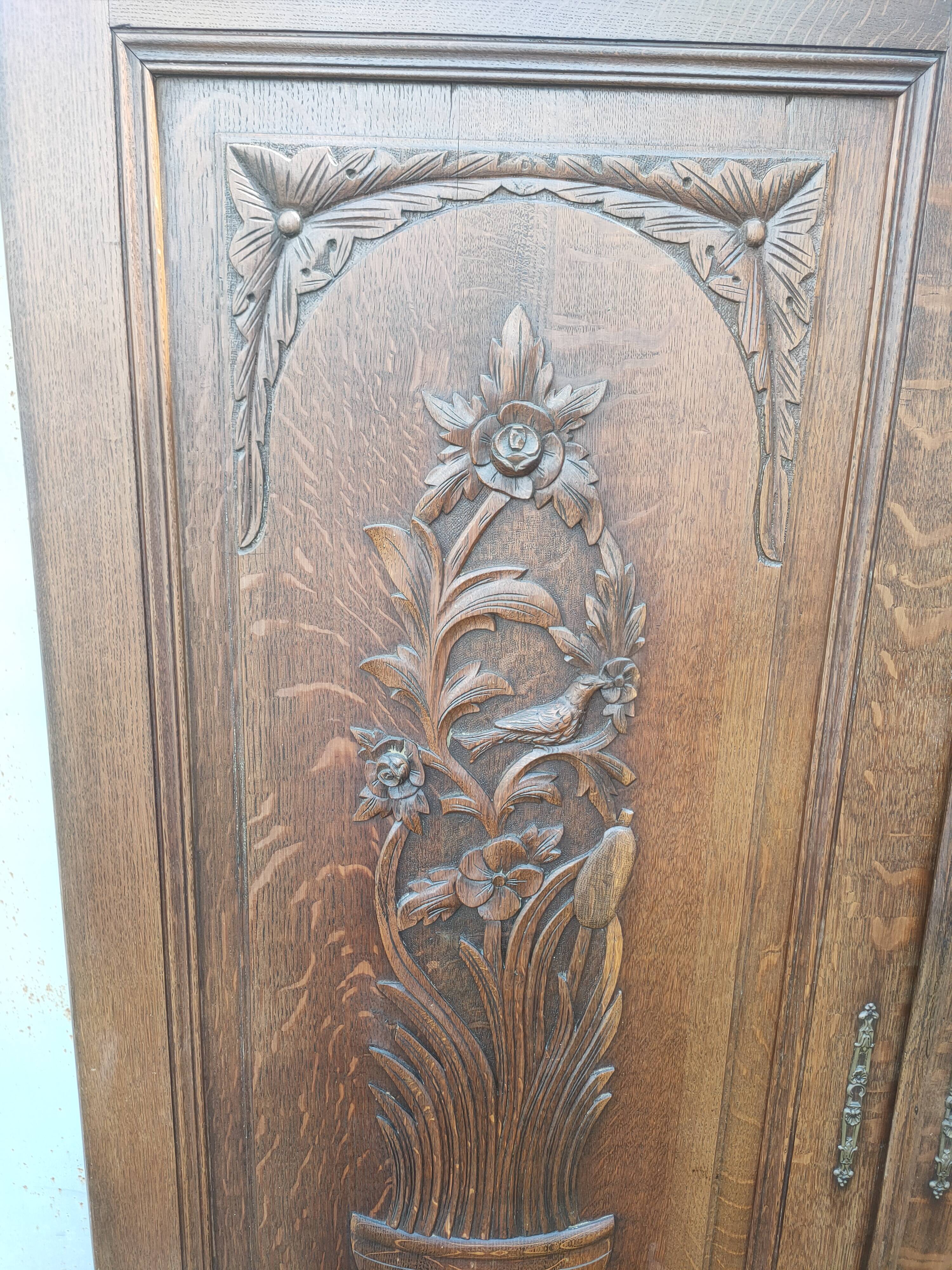 pair of antique solid oak cabinet doors with bird decor
