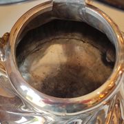 Ancient samovar tea fountain in silver metal