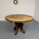 Round table in solid wood, thick top, vintage brutalist style from the 1960s.