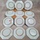 Set of 12 small antique plates by Alfred Renoleau, different designs.