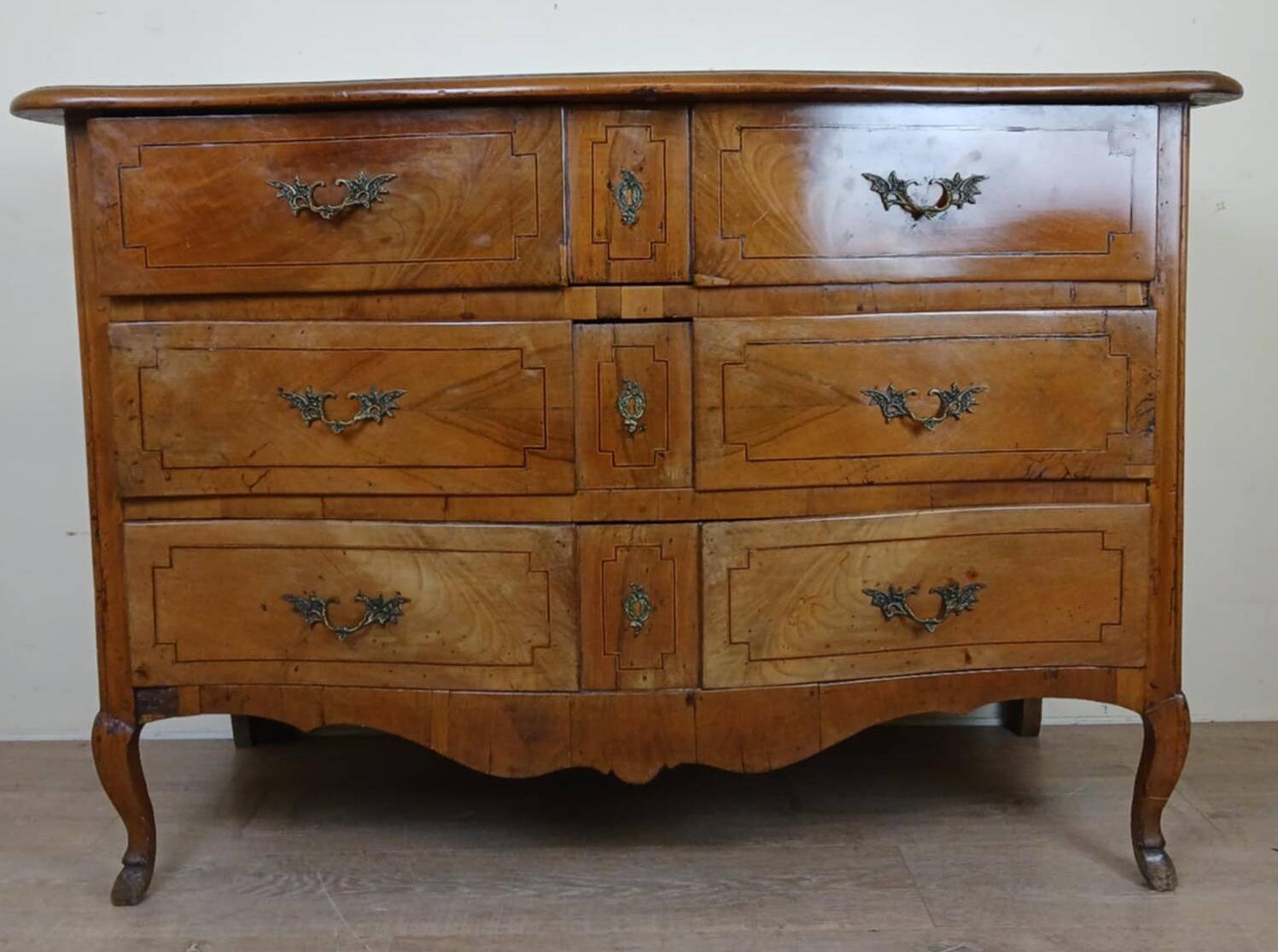 Louis XV period curved chest of drawers in elm and marquetry fillets circa 1750