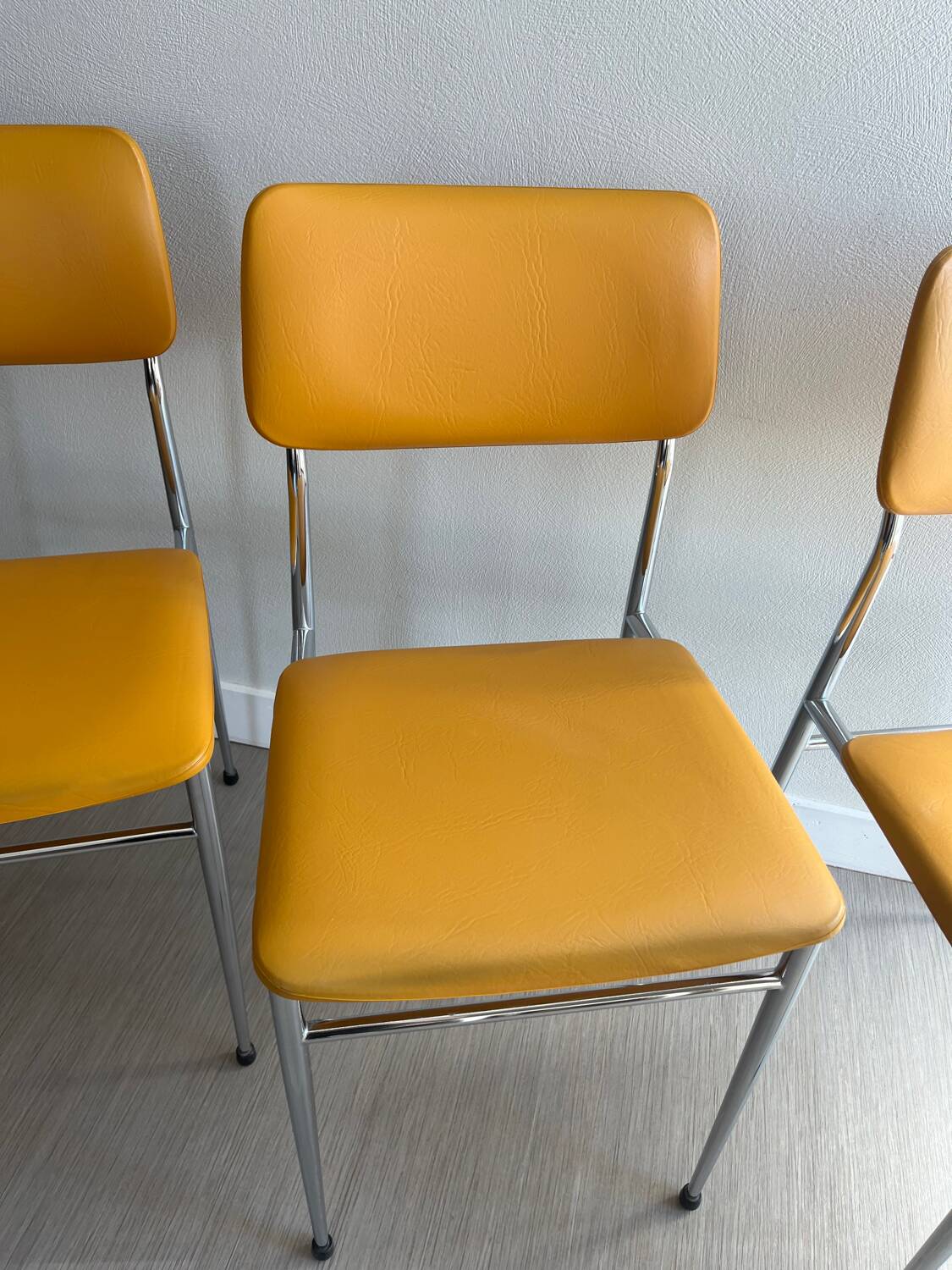 LM vintage chrome and orange/mustard yellow faux leather chairs