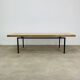 1950s modernist coffee table, wood and black metal.