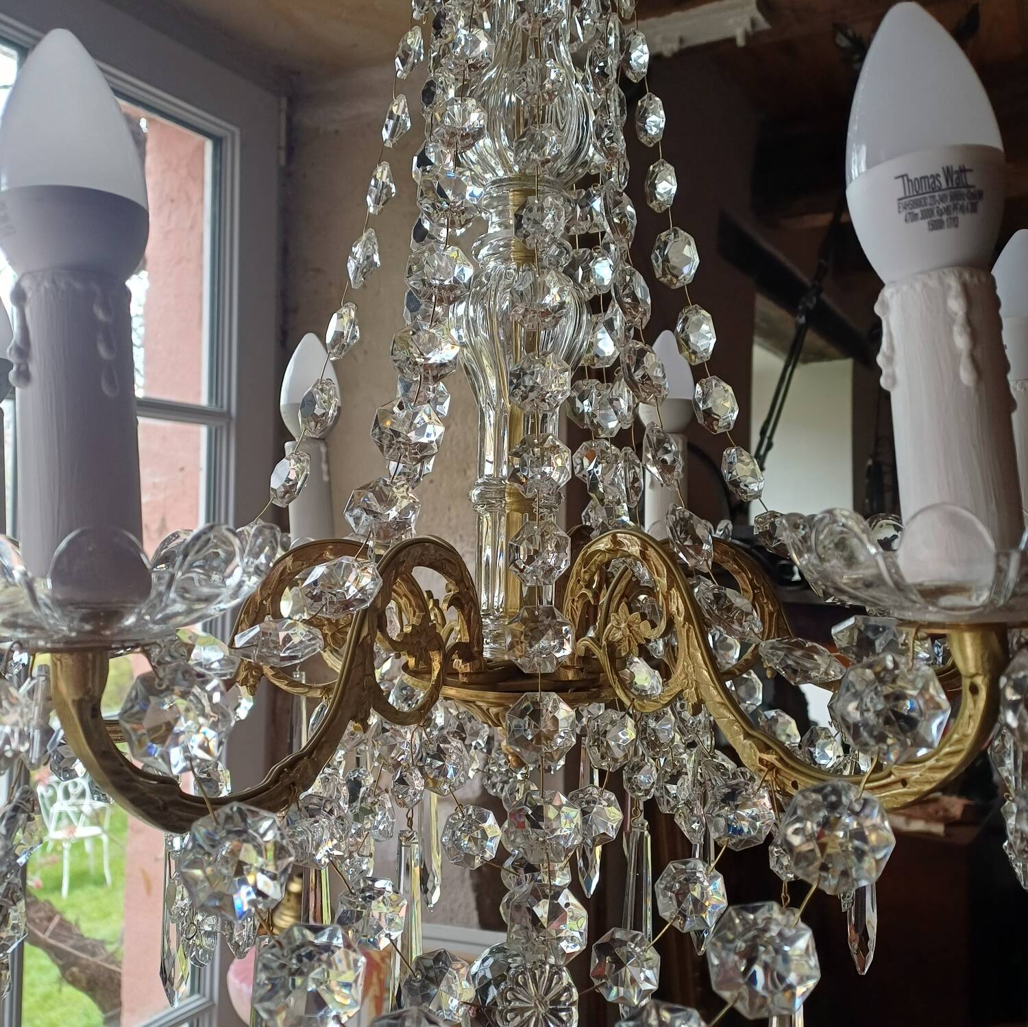 Antique chandelier with pendants in bronze and crystal.