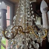 Antique chandelier with pendants in bronze and crystal.
