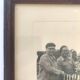 Fishing trophy with radiant faces, c. 1950. Black and white photograph.