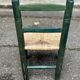 Vintage children's chair in solid wood with a straw seat in green.