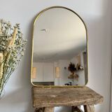 Brass wall mirror in the shape of a handmade holder