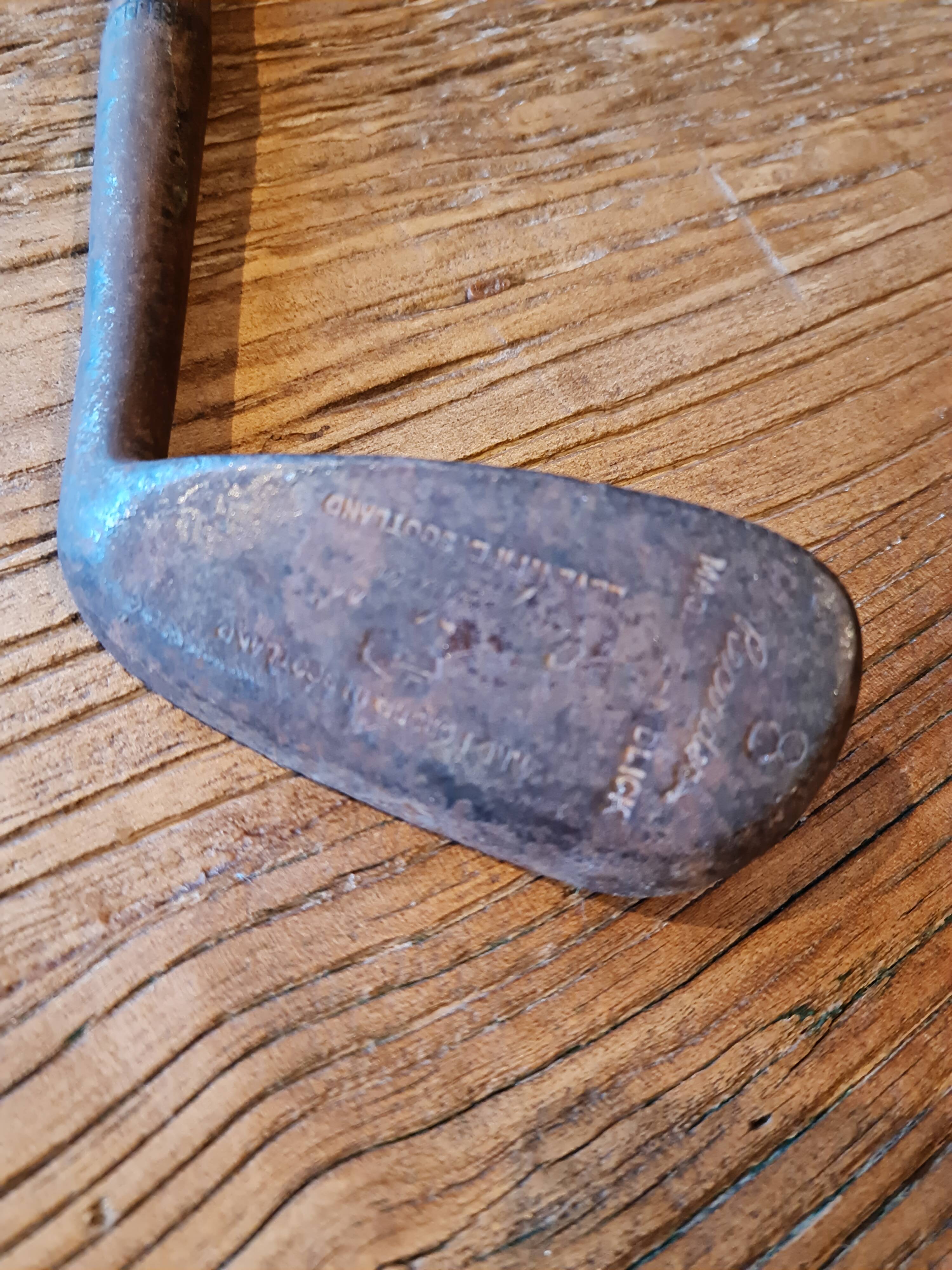 Wood, leather and metal golf club