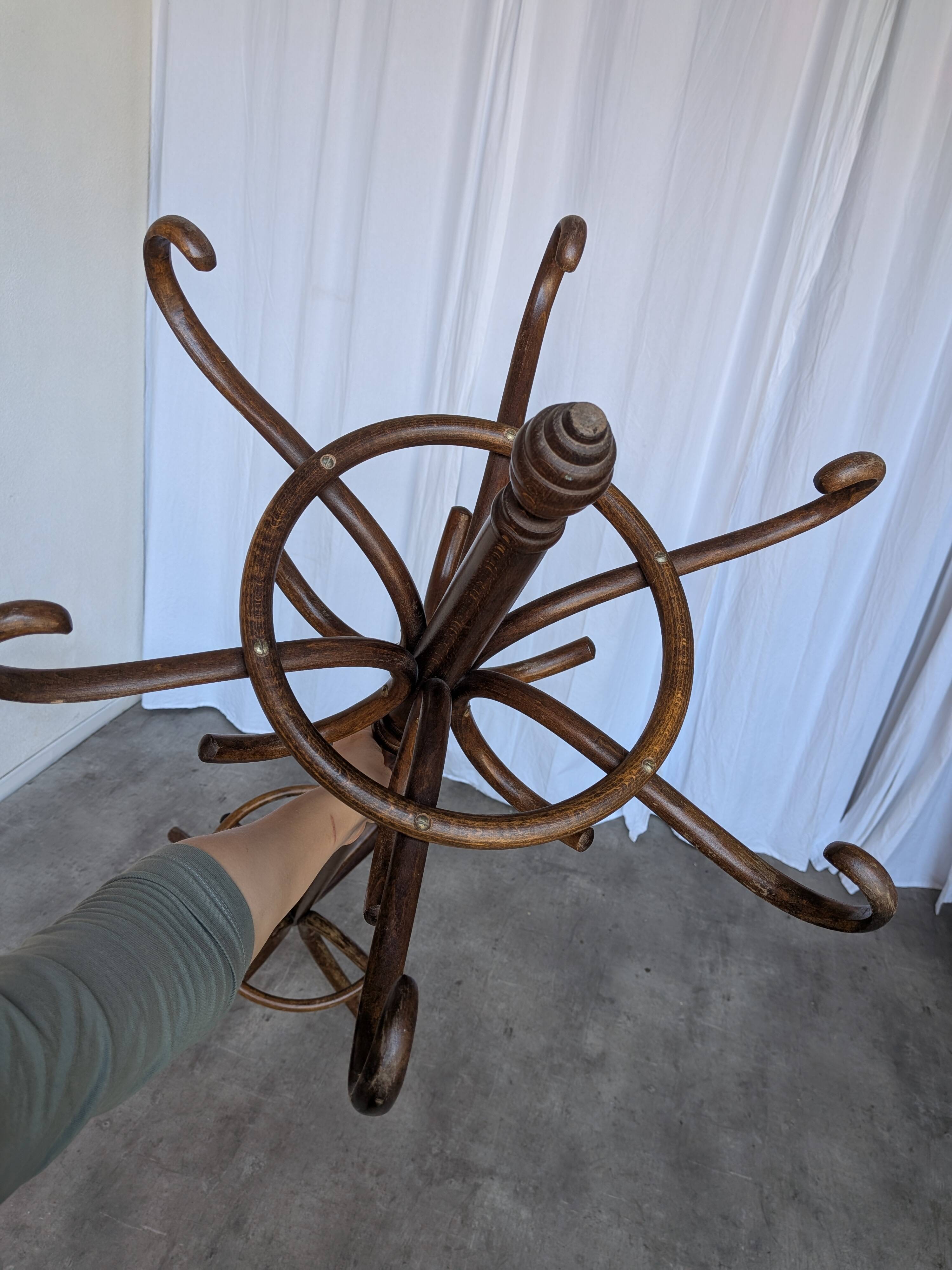 Vintage bentwood coat rack in Thonet style / Dark wood coat rack with shadow.