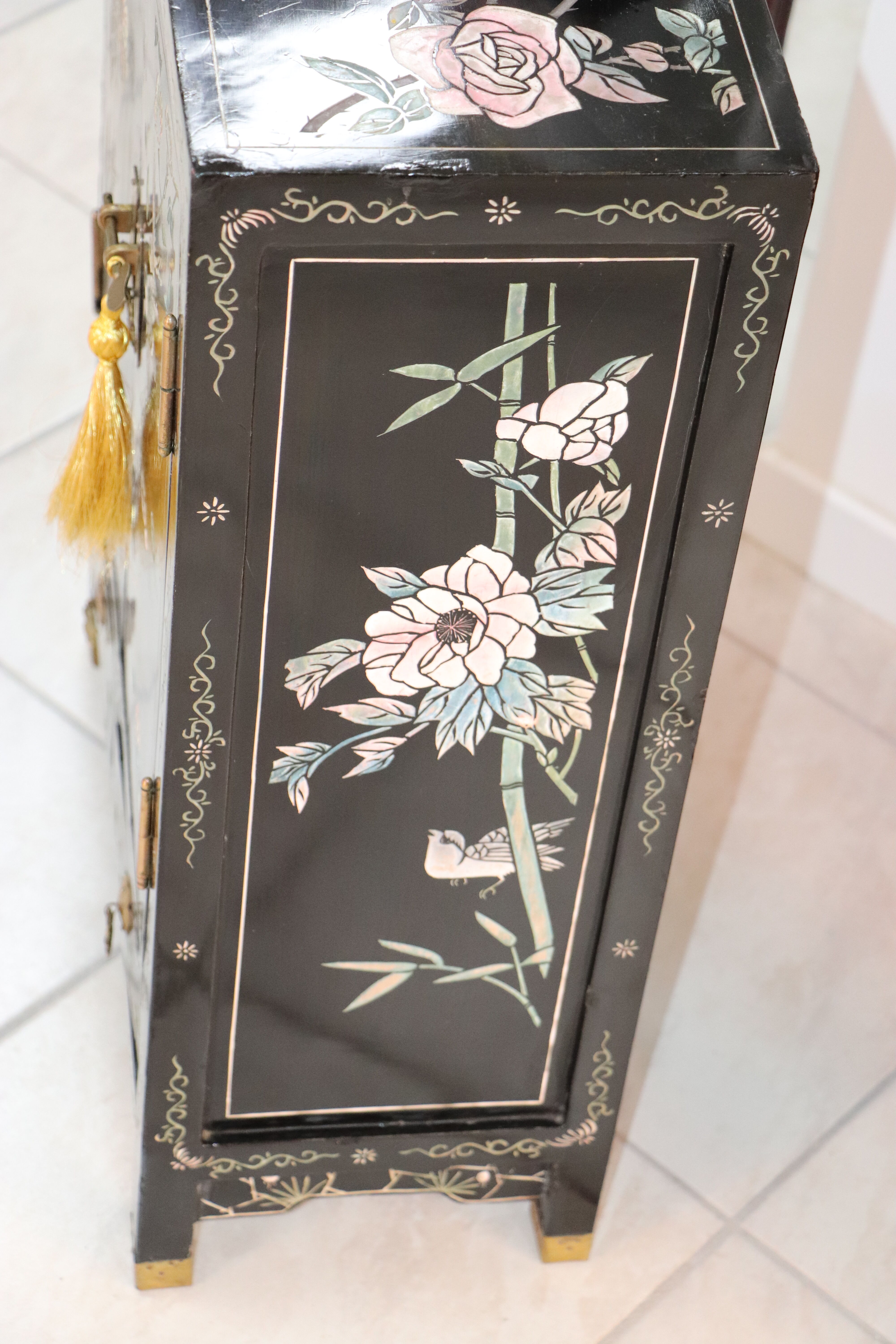 Small storage or bedside table lacquered black, incised and painted