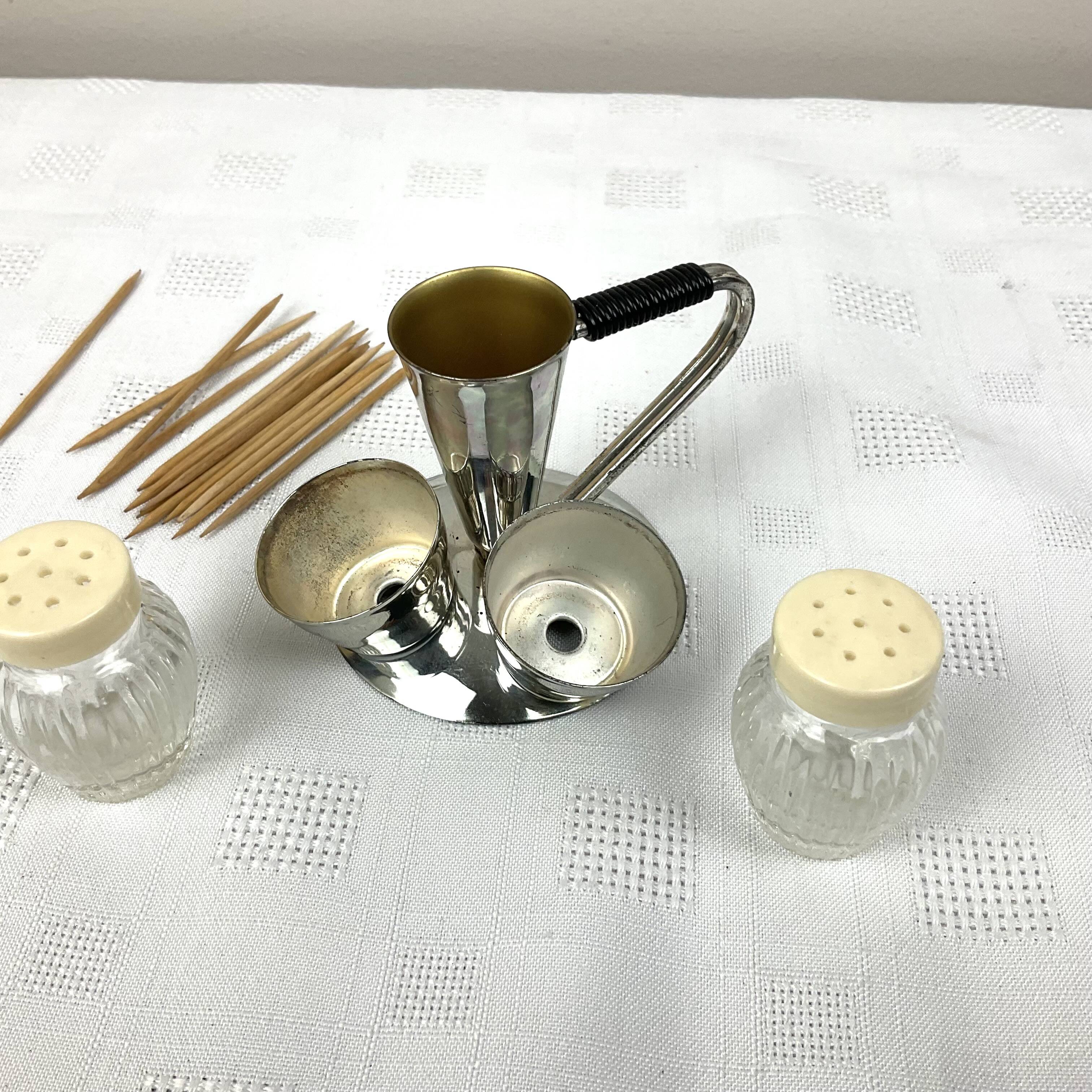 Vintage salt and pepper shakers and their chrome metal support