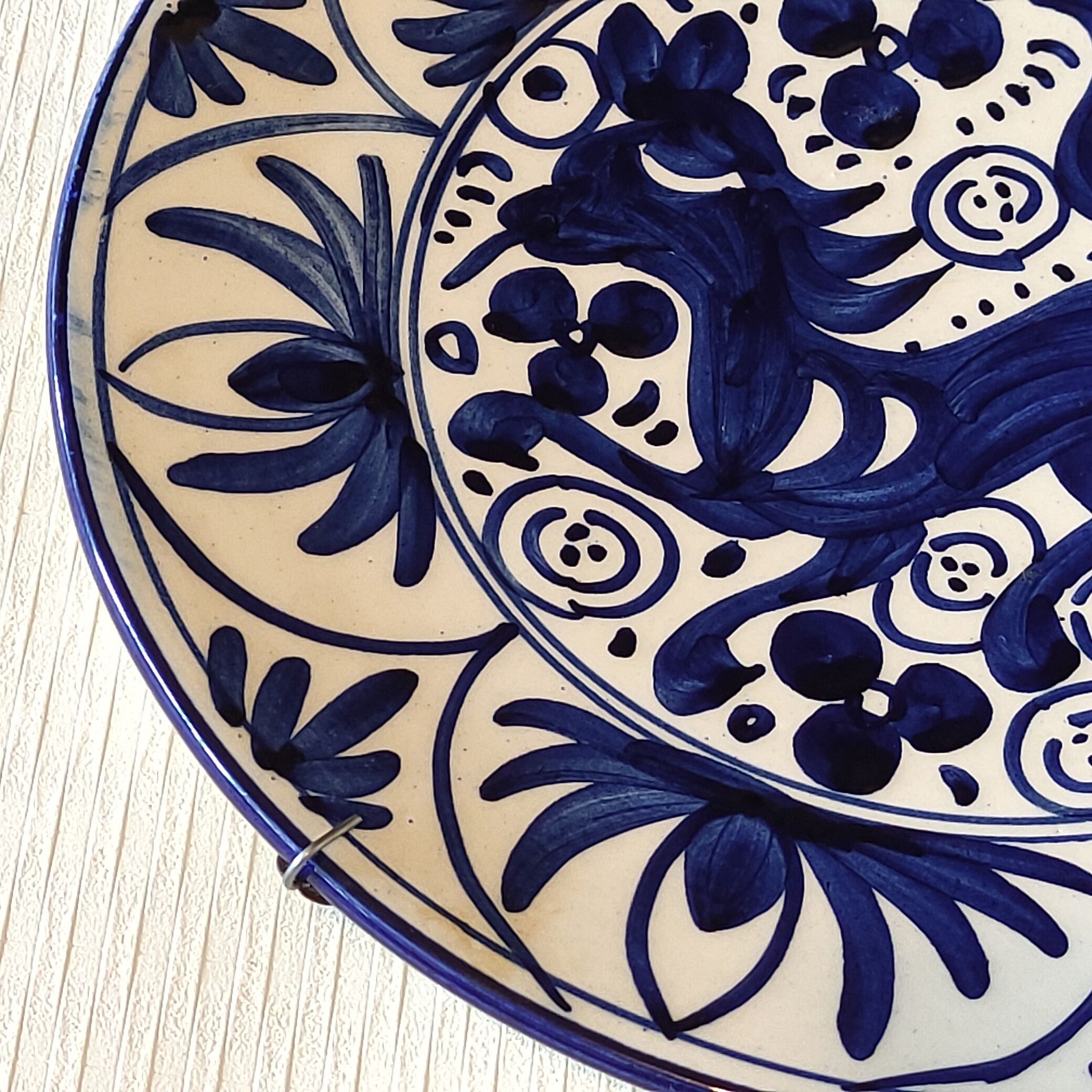 Hand-painted decorative plate decorated with a blue chimera pattern