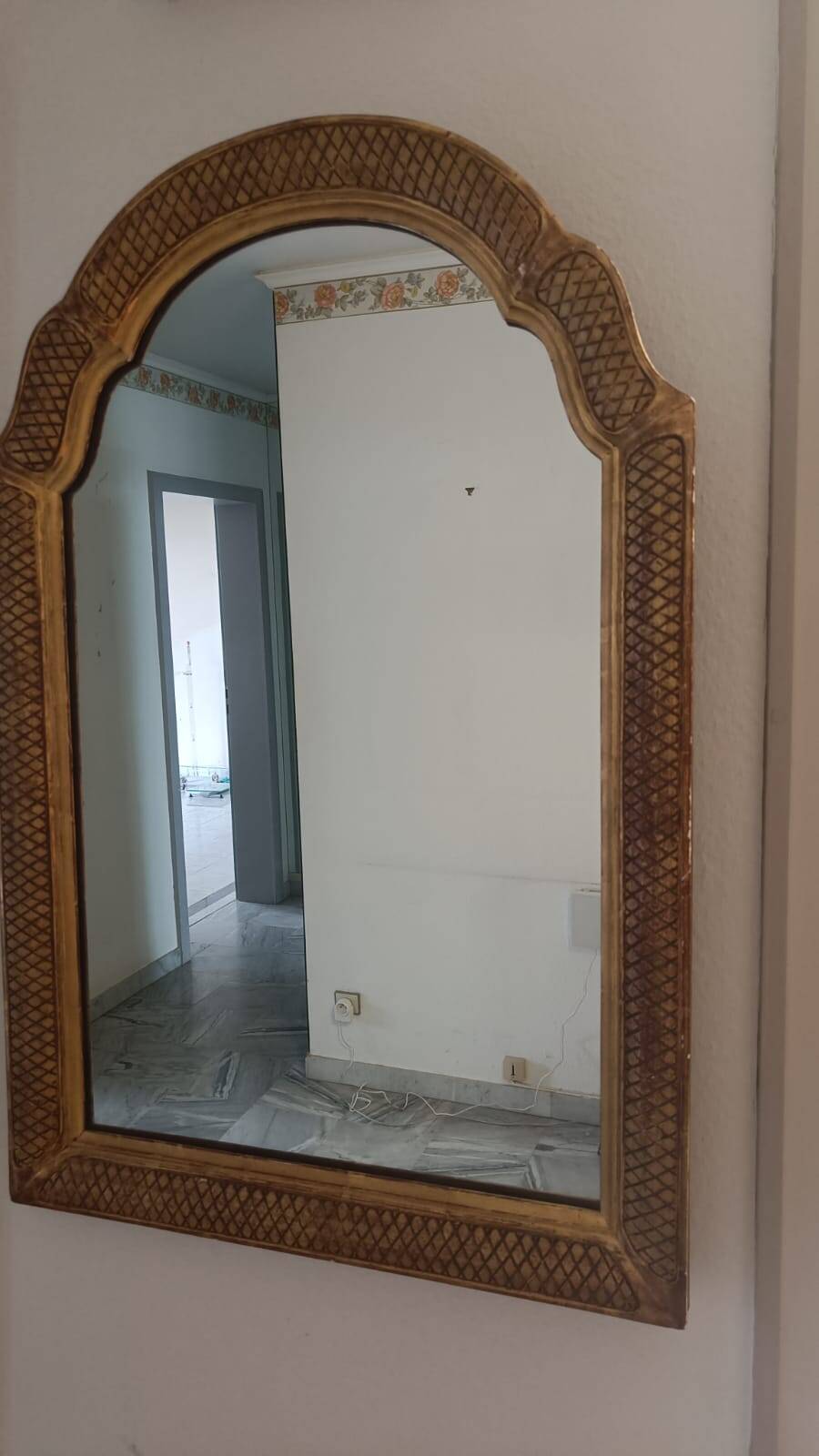 Italian mirror with a sculpted patinated arch, neo-Renaissance style.