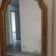 Italian mirror with a sculpted patinated arch, neo-Renaissance style.