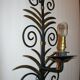 Wrought iron sconces decorated with golden pineapple leaves