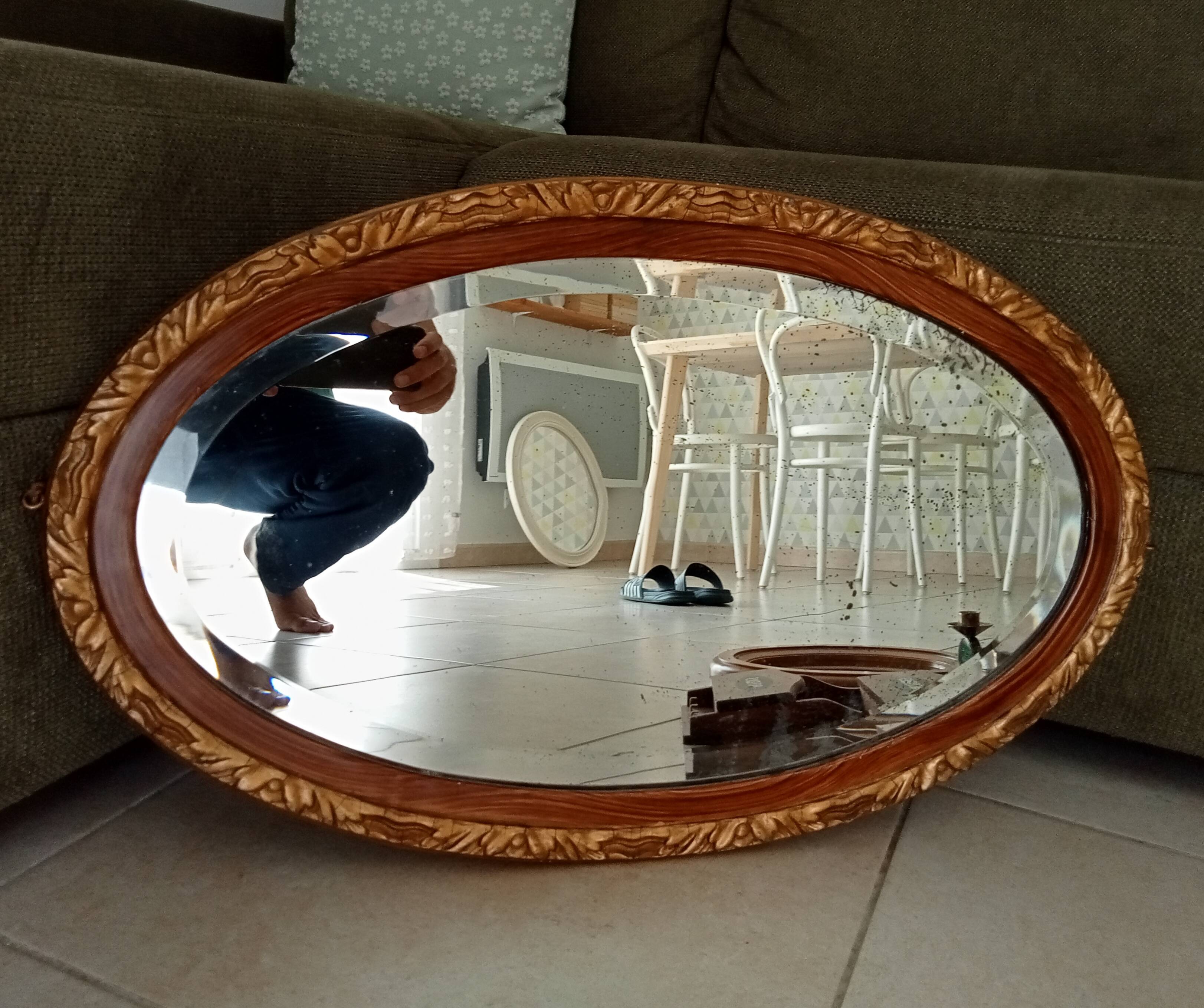 Antique oval mirror with beveled glass in wood and stucco, 19th century