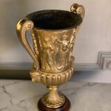 Golden bronze urn, base of red griotte marble.