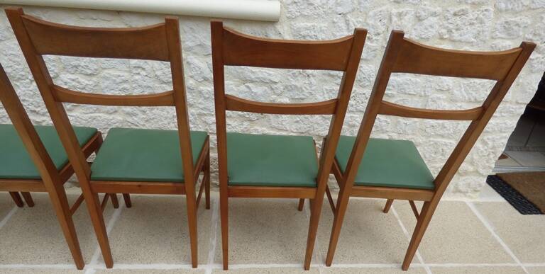 6 modern chairs with banded backs and green faux leather seats