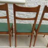 6 modern chairs with banded backs and green faux leather seats