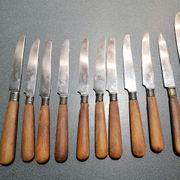 Old table knives and dessert knives, wooden handles, stainless steel blades