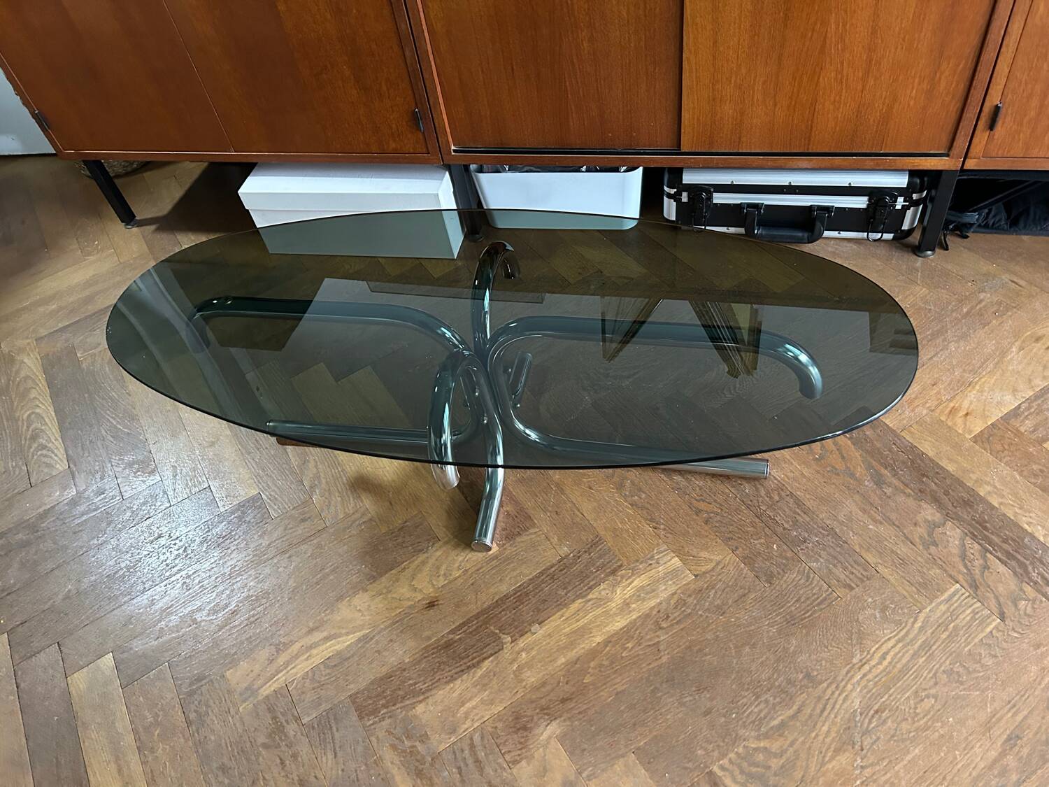 70s design oval coffee table in smoked black glass with chrome legs.