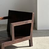 Small low armchair in varnished brown wood