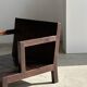 Small low armchair in varnished brown wood