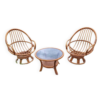 Set of 2 swivel armchairs and 1 wicker coffee table.