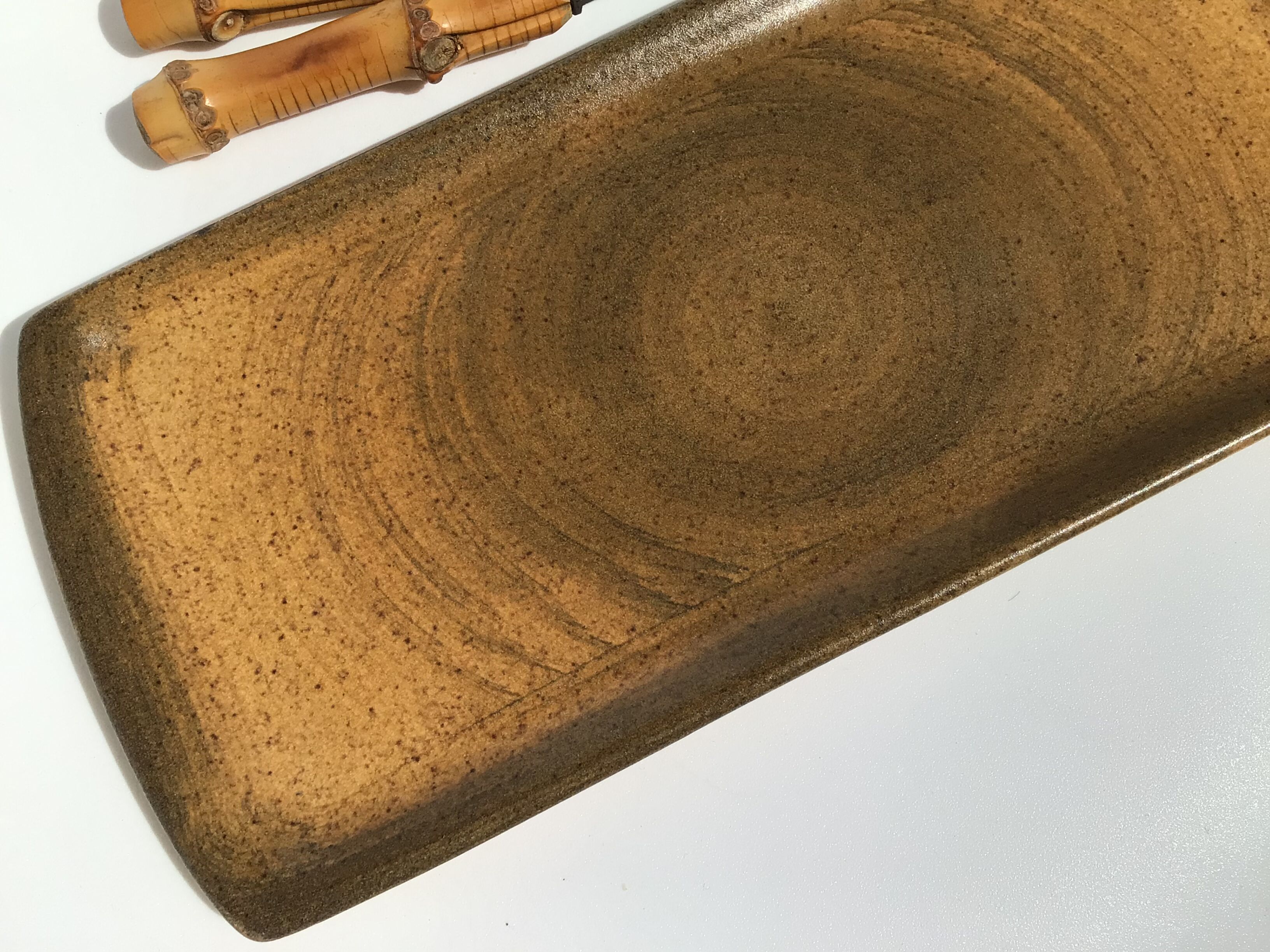 Speckled brown Longchamp sandstone cake dish