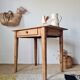 Small old farmhouse table in raw wood.